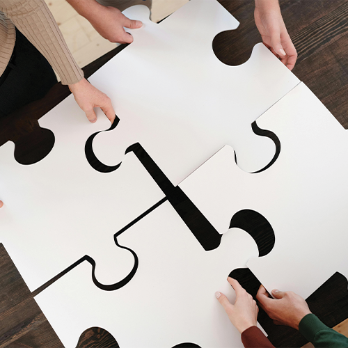 Image of hands holding jigsaw pieces